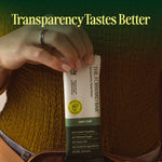 Hand holding a package of 'The Forward Bar' with text 'Transparency Tastes Better' on a green background. - view 9