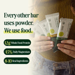 Person holding protein bars with text about ingredients and benefits - view 6
